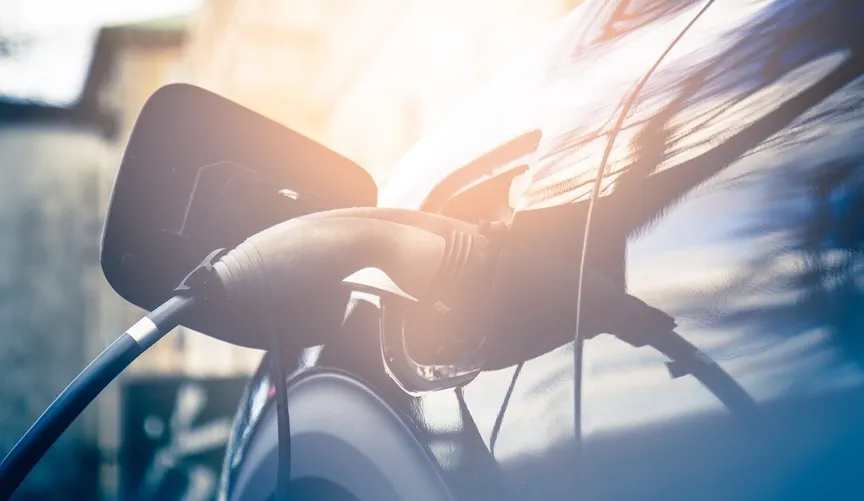 Close-up of an electric vehicle plugged in and charging